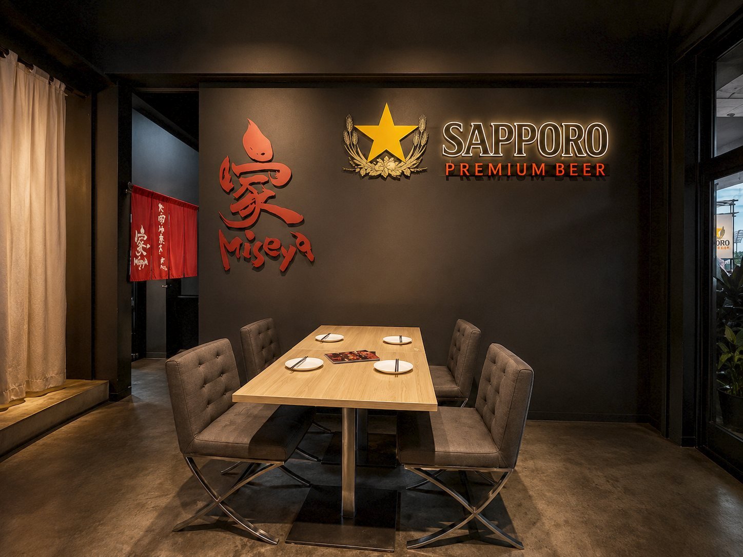 Private dining table beneath the Miseya logo and Sapporo neon sign